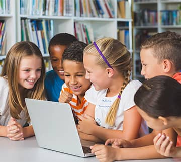 Smiling student using blocks as eyeglasses