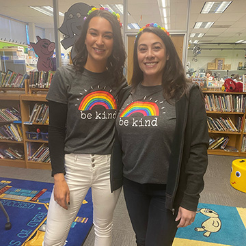Mrs. Suzanne Lang and Ms. Dara Weiss wearing be kind rainbow t-shirts