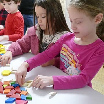 Two students building a Lego project