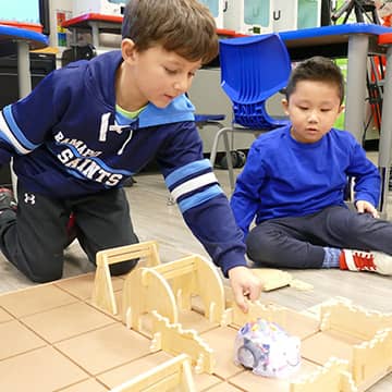 A student working with jumbo colored pencils