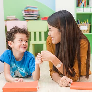 A teacher fist bumping a student