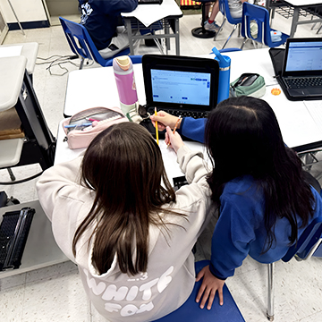 Two students working together in the classroom