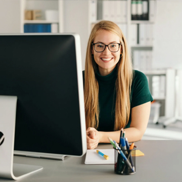 Happy school secretary at her desk