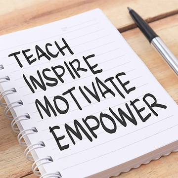 A notebook with the words Teach Inspire Motivate Empower