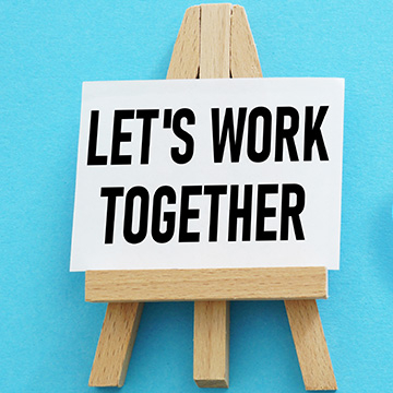 A sign that reads Let's Work Together