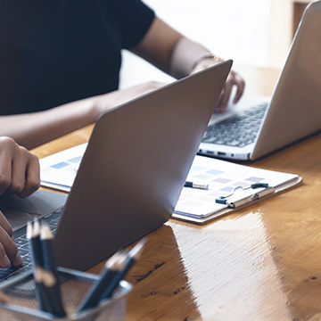two people working on laptops
