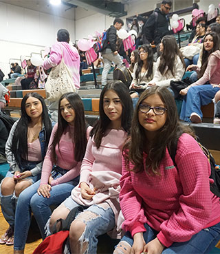 Students sitting on the bleachers for an assembly