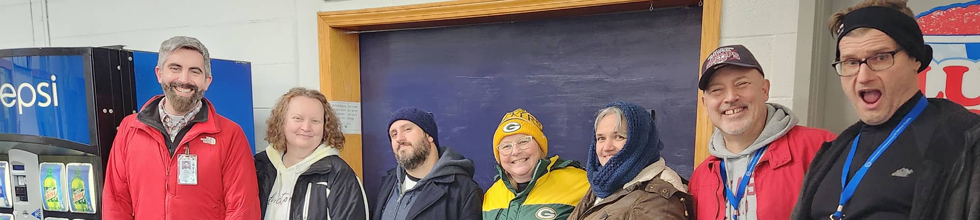 Staff smiling in front of snack bar