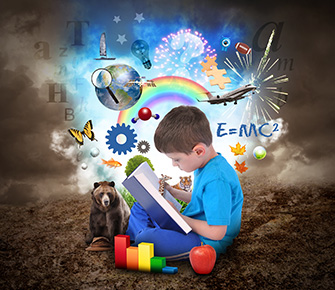 Boy reading a book with different education items around him