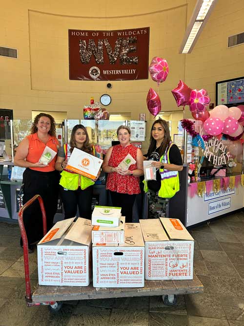people standing behind Amazon hygiene kit donations