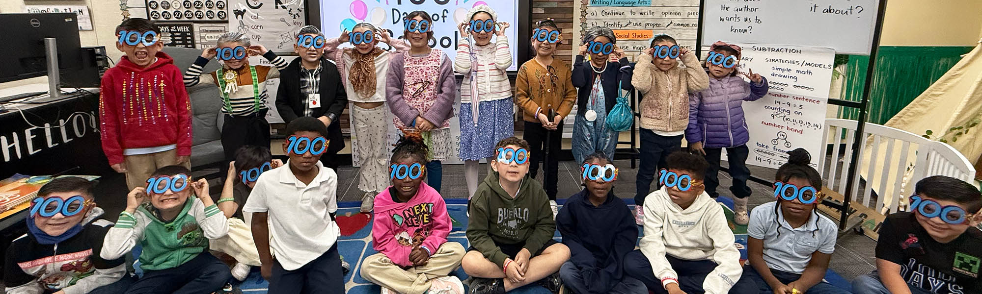 Group of students wearing 100 Day glasses in the classroom