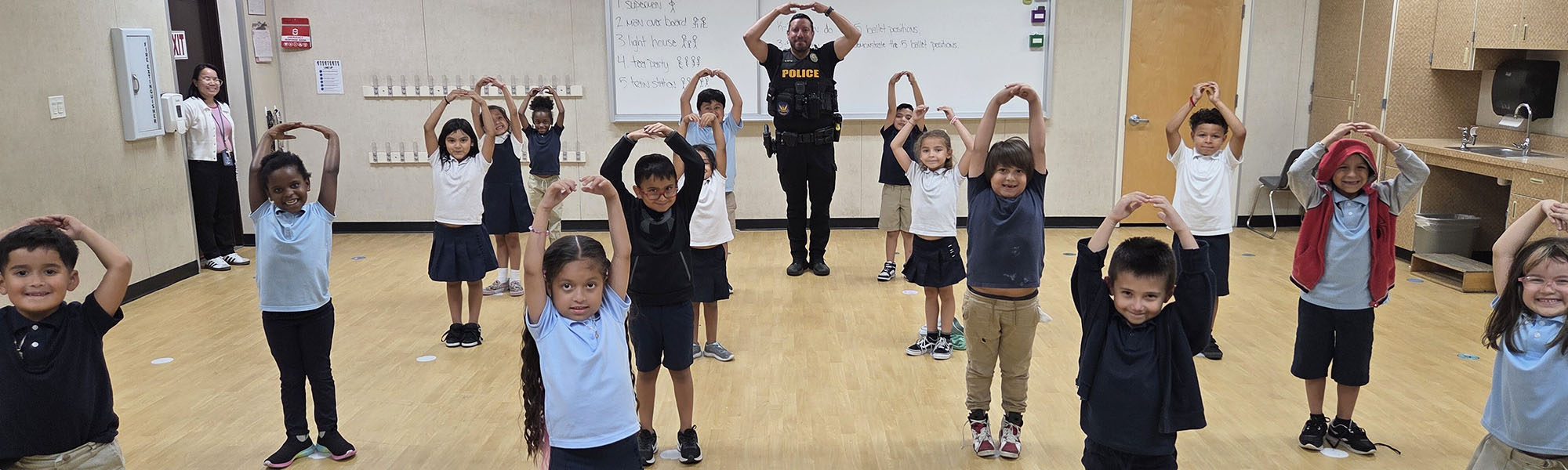 Elementary students enjoying an activity with local police