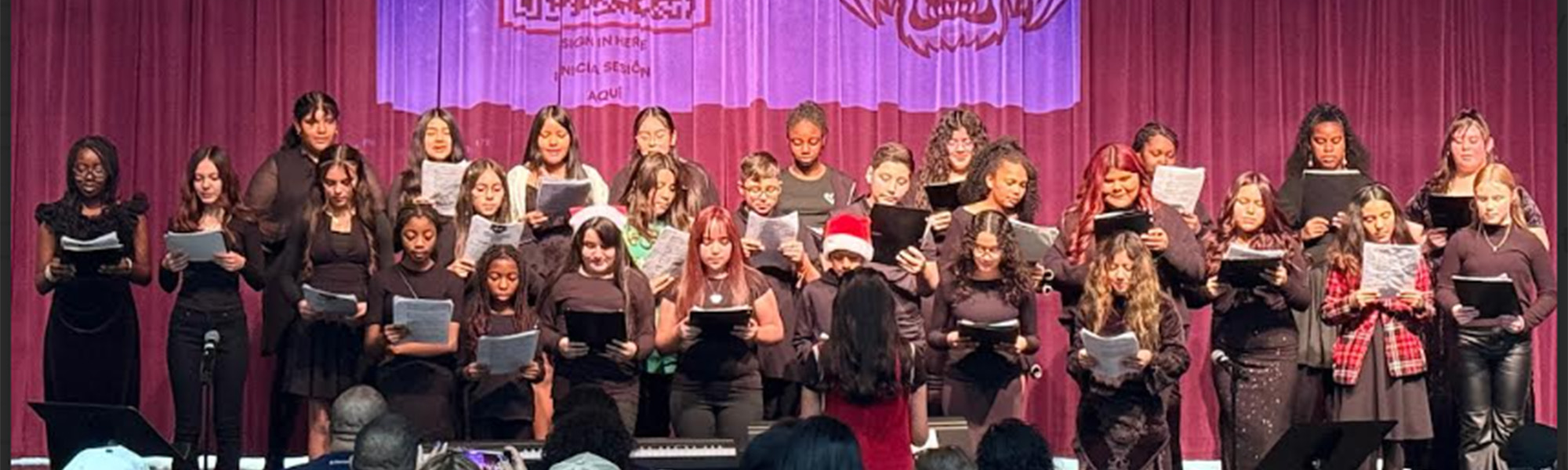 Students singing on stage
