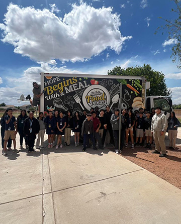 Students in front of a mobile food pantry truck