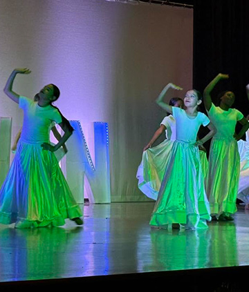 Students dancing in shiny skirts