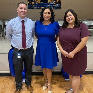Three staff members smiling