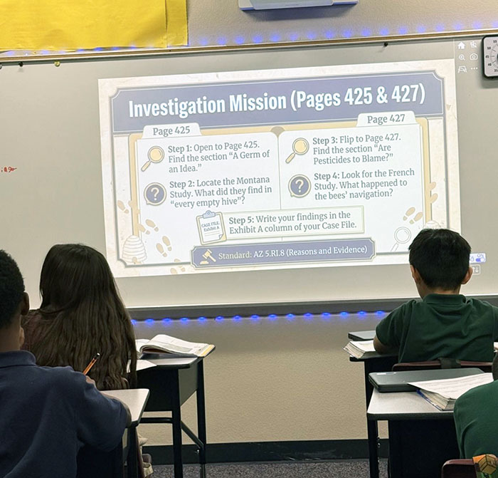 Mrs. Cross displaying an Investigative Mission presentation on the whiteboard for her students in the classroom