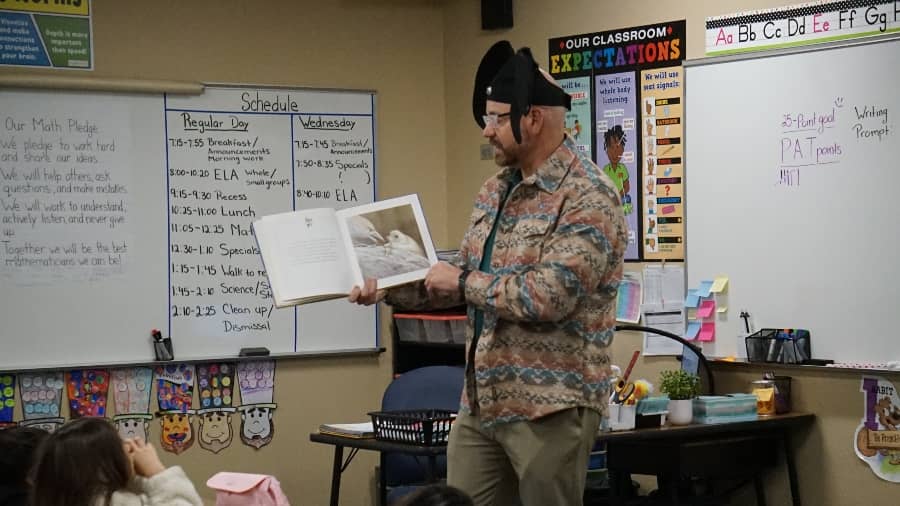 guest reader reading to a classroom of students