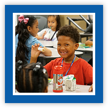 Happy elementary boy enjoying lunch linking to Littleton Foundation for Education