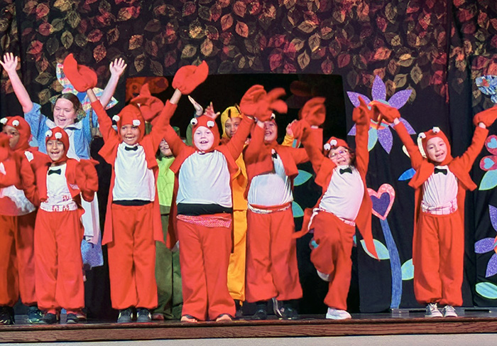 Students in costumes on the stage