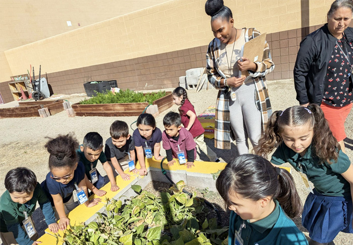 58������ students and teachers admiring the school garden