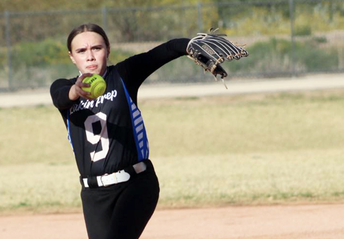 Female softball athlete getting ready to pitch the ball