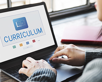 Parent looking up curriculum on her laptop