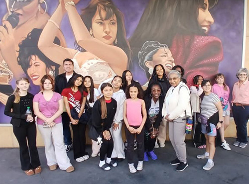 Freeman Fine Arts Academy in front of a mural