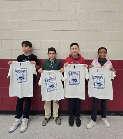 Quentin Sharks holding up their congratulatory tee shirts