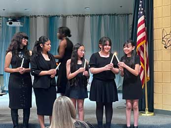 students holding candles
