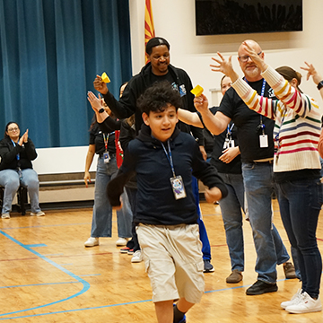 Student receiving award in the gym