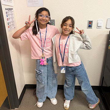Two happy girls dressed as twins