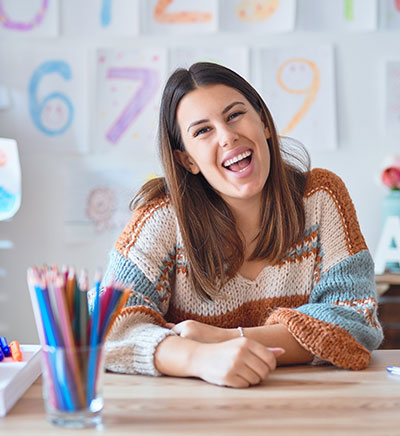 Teacher smiling at her desk