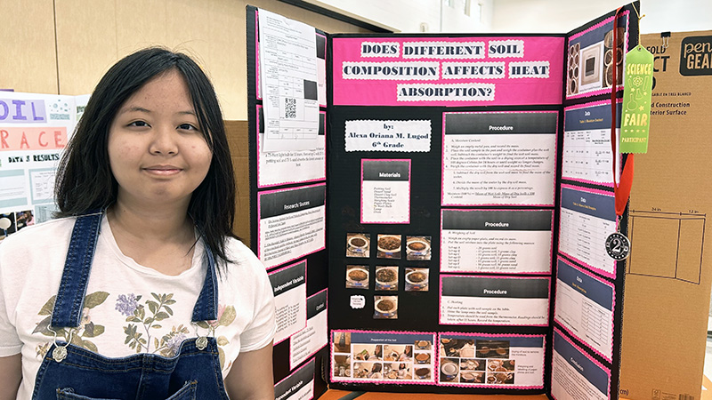Alexa Lugod next to her Westside Impact Regional Science and Engineering Fair project