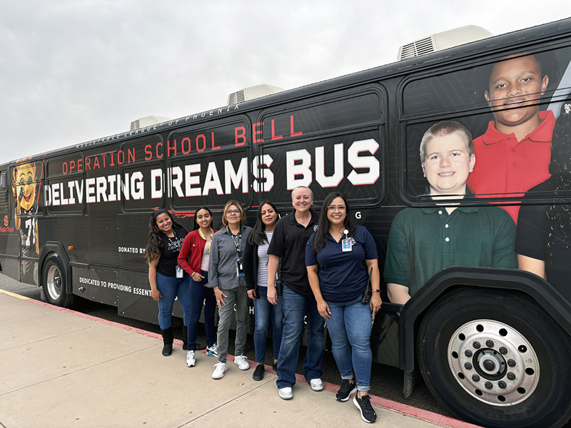 SMMS staff in front of Operation School Bell Delivering Dreams Bus