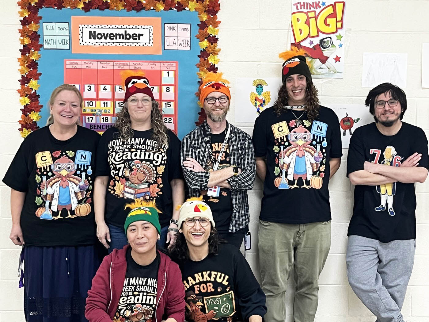 Group of happy staff members wearing fun turkey t-shirts
