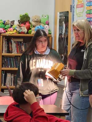 Staff showing students how a light works