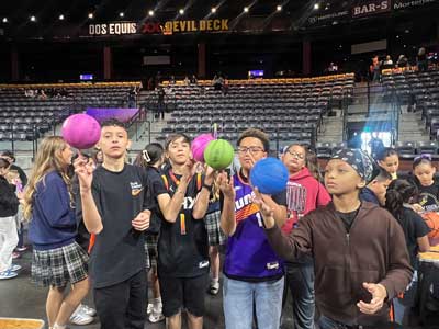 Students twirling basketballs on their fingers