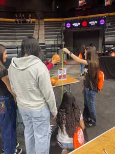 Students watching an experiment with basketballs