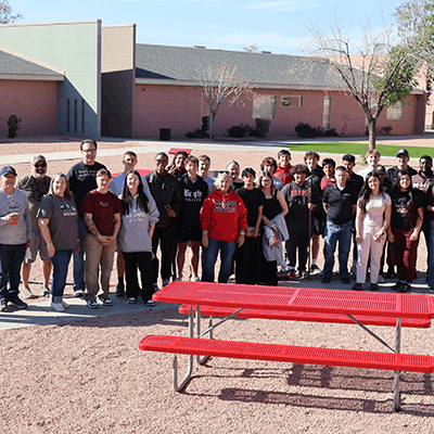 8th graders and Brophy College Prep volunteers outside by a picnic table they built