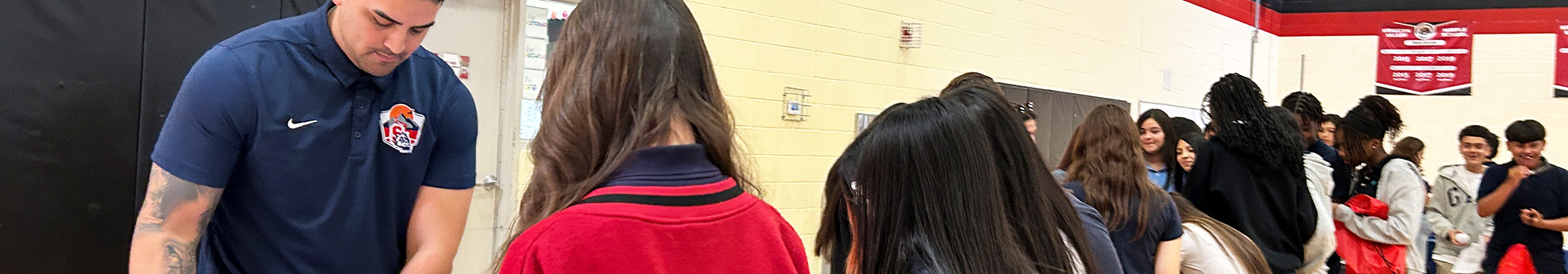 Students attending an information fair in a school gym