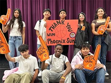 Group of happy students holding up Thank You banners