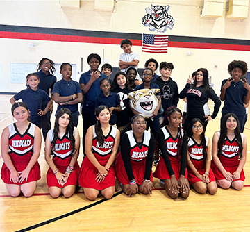 sidebar_OurSchool Group of cheerleaders in the gym with school mascot