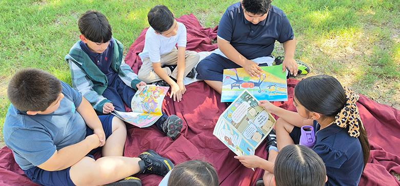 Group of students reading outside