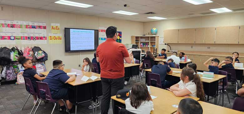 Teacher talking to students in a classroom
