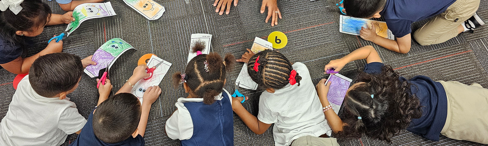 students cutting out pictures