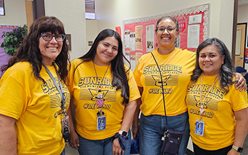 4 staff members with matching Sunridge shirts on