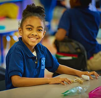 Smiling student at a table
