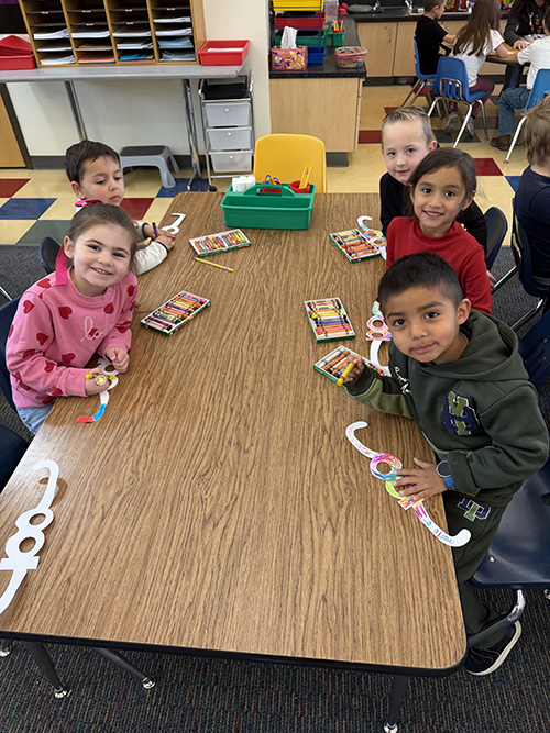 Group of students working on an activity at a classroom table