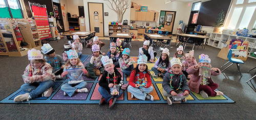 TK and kindergarten students celebrating 100 days wearing paper hats